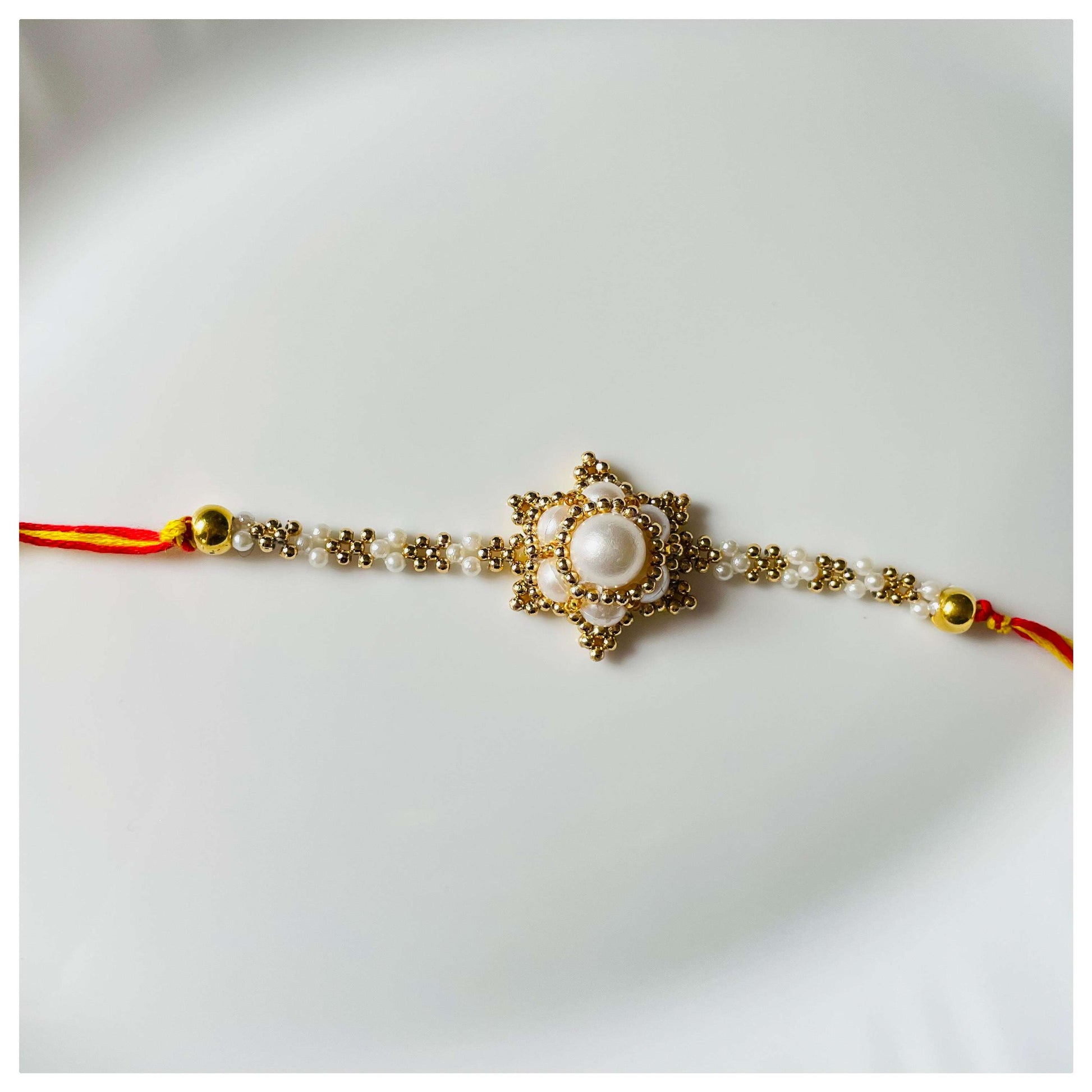 White Floral Bhai Rakhi - beattrangi